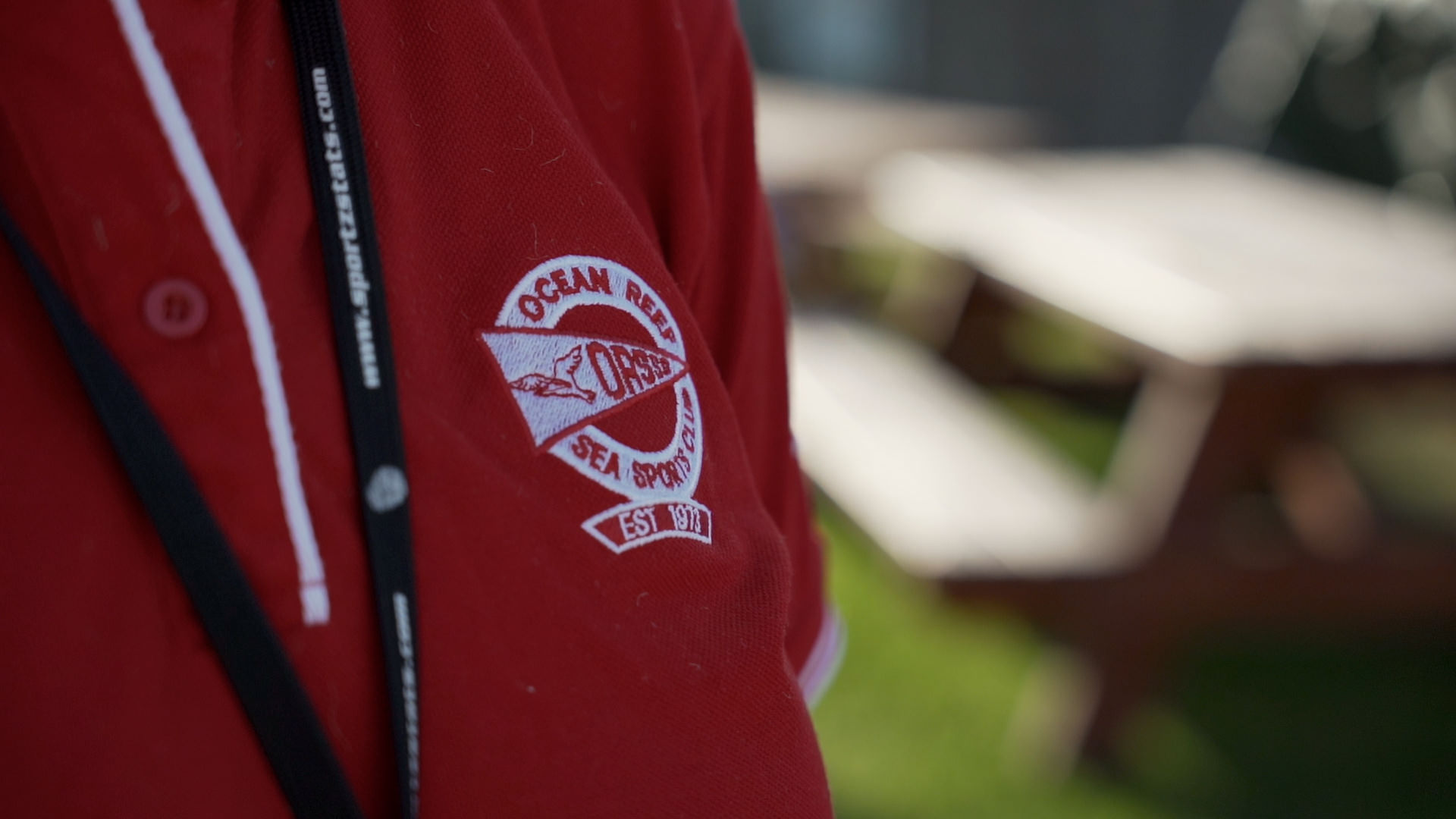 Red polo shirt with Ocean Oasis Sea Sports logo