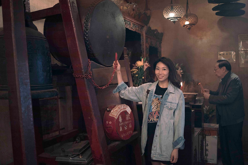 Hitting the drum in Man Mo Temple