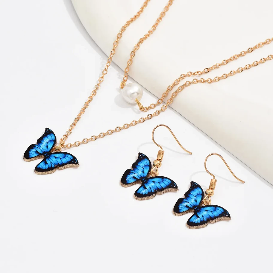 Conjunto de joyería collar multicapa y aretes mariposa azul
