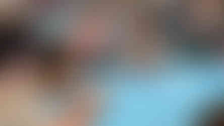 Students working out math problems on blue paper