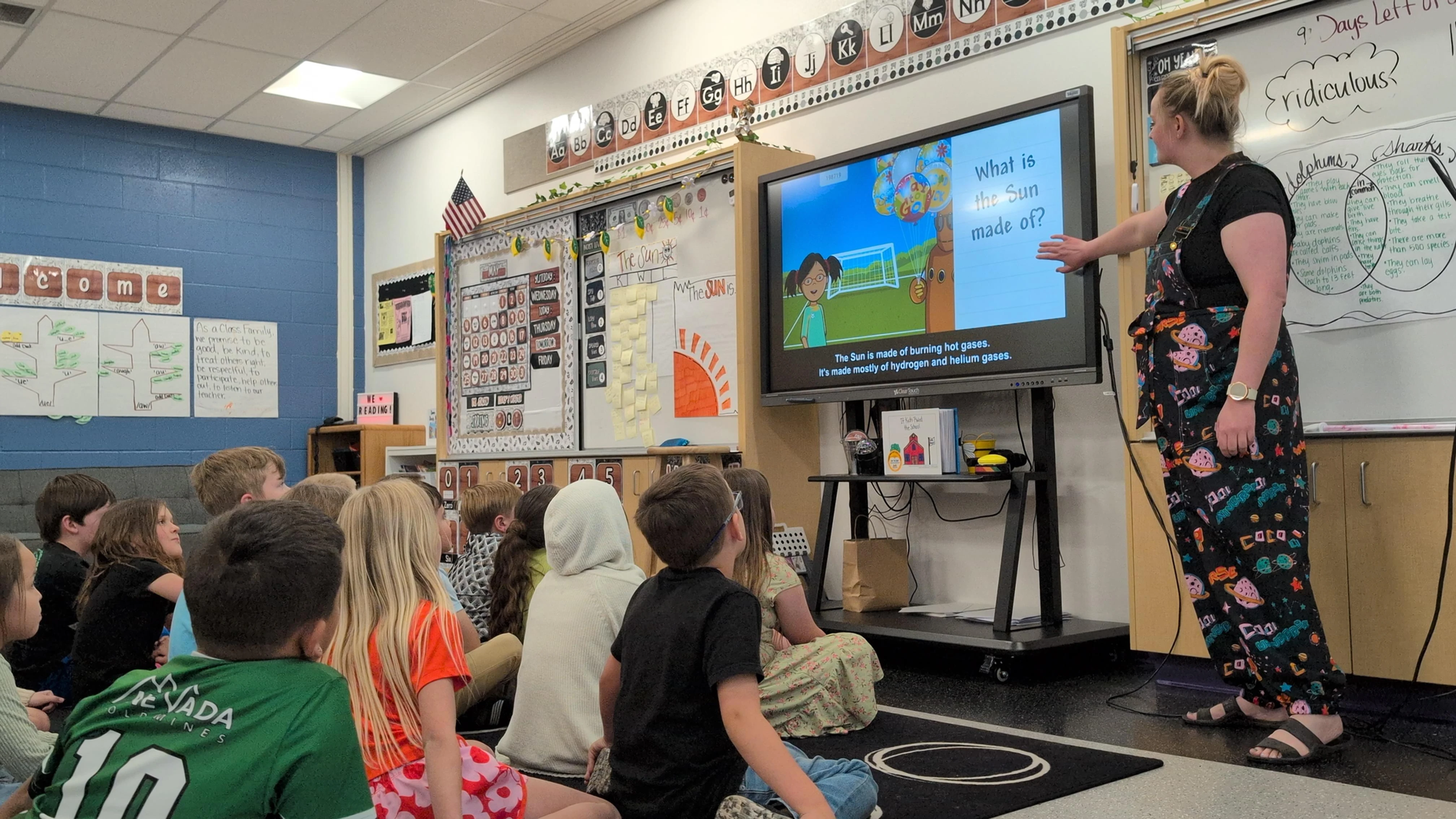 Students watching a BrainPOP Jr. movie on the sun together in a bright classroom 