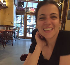 Woman smiling with brown hair and brown eyes
