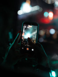 Person filming Jason Derulo performing at First Direct Arena in Leeds on a smartphone during a live concert.