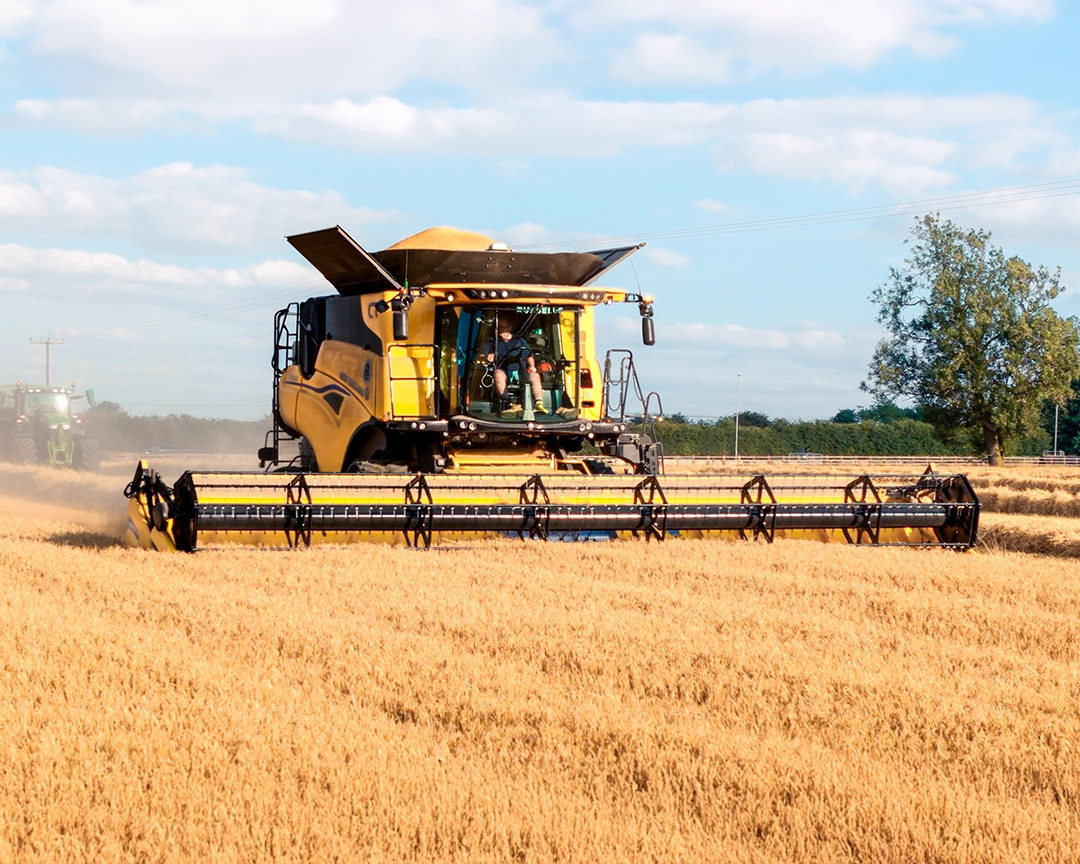 combine harvester in the field using a drone