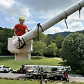 Ezra working at face level inside a bucket truck elevated above the ground.
