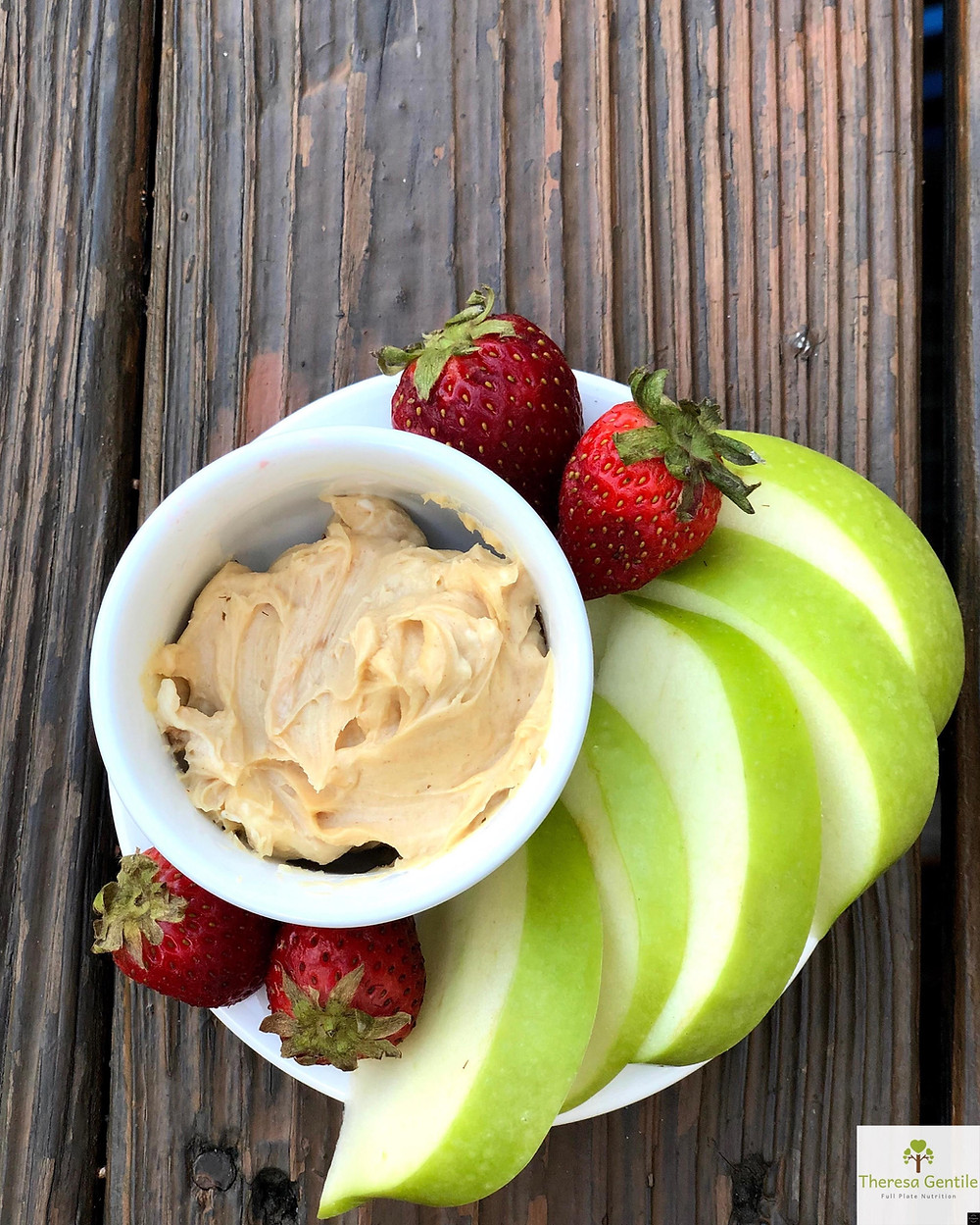 Apples and strawberries on a plate with mascarpone peanut butter dip