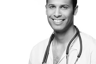 Young doctor with stethoscope around neck and super white teeth