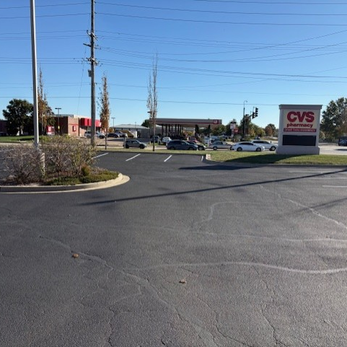 Sealed concrete joints and cracks in a parking lot at a at a large logistics facility.