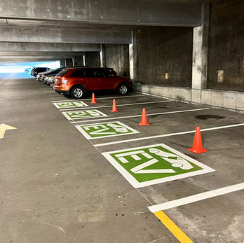 Fresh EV Parking logos in a parking garage.