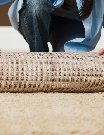Woman Rolling Carpet