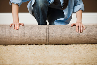 Woman Rolling Carpet