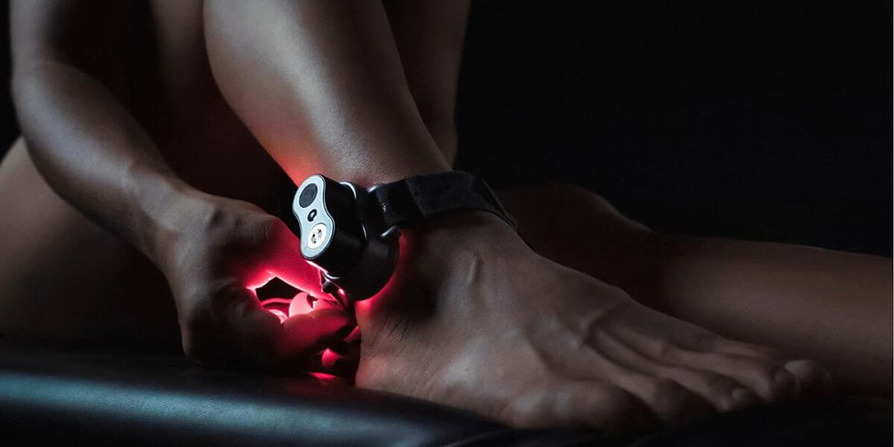 Woman using red light therapy for ankle joint pain.