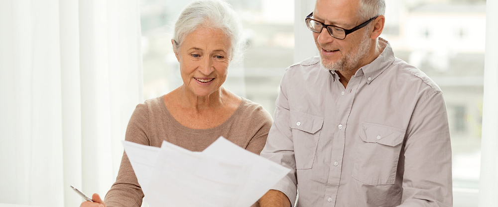 Senior couple reviewing financial documents.