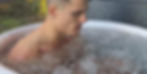 Athlete performing cold therapy in ice bath.