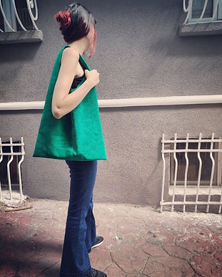 A women wearing a green suede hobo bag