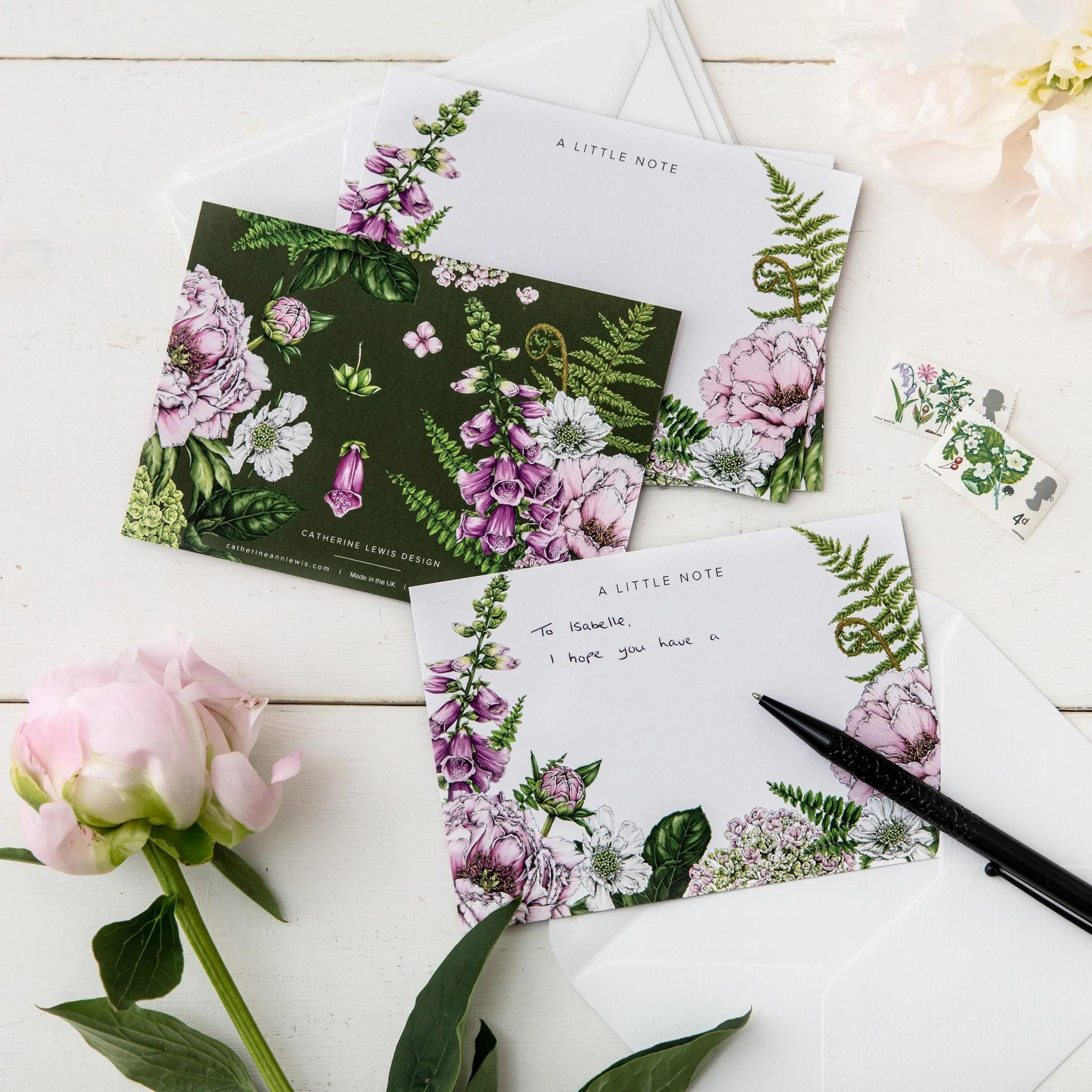 Intricately designed floral notecards, with a darg green base and 'A LITTLE NOTE' printed at the top end.