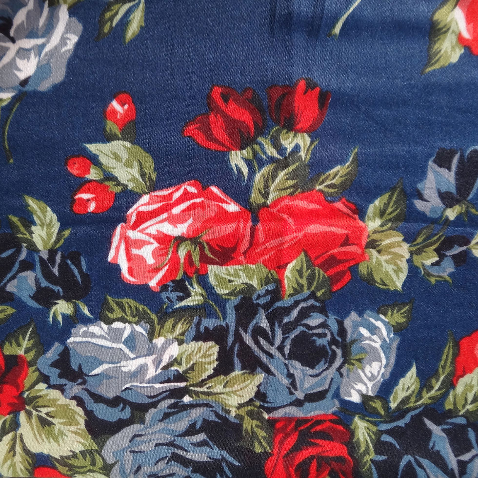 Pashmina rose print scarf featuring bold red roses on a blue base.