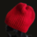 Mannequin with vibrant red hand-knitted women's wool beanie featuring classic ribbed design.