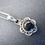Thumbnail: A simple handcrafted necklace featuring a black Onyx pendant with floral detailing hung from a silver plated fine chain.