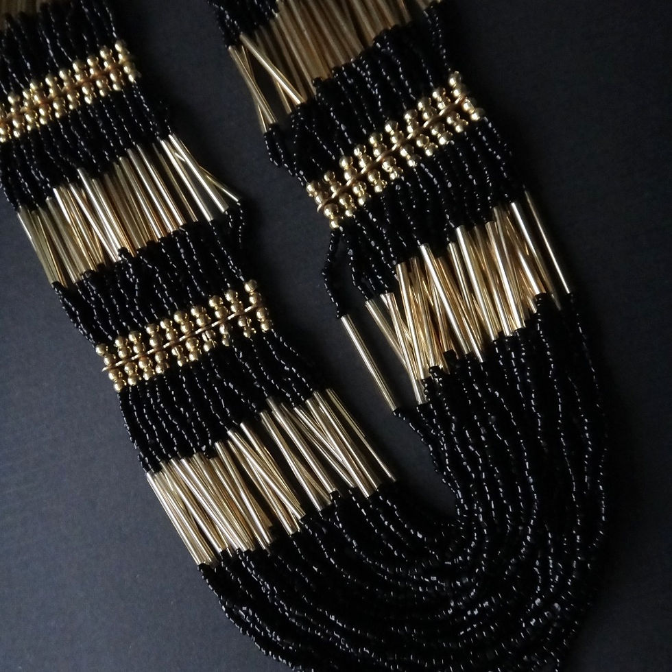 Handmade beaded necklace featuring layers of black and gold beads in alternating pattern.