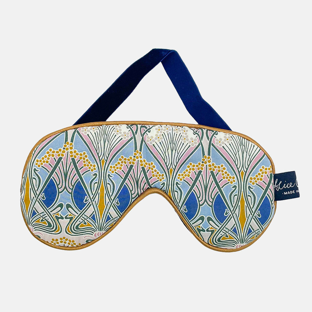 Liberty Ianthe Nouveau Eye Mask with a bronze piping and complemented by a midnight blue velvet back and a matching strap.