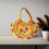 Thumbnail: Large Mirror Embroidered Tote Bag featuring colourful embroidery and an elephant on a yellow base.