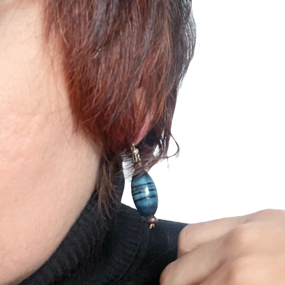 Oval ocean green Handmade Drop Earrings with horizontal stripes and a brown bead at either ends.