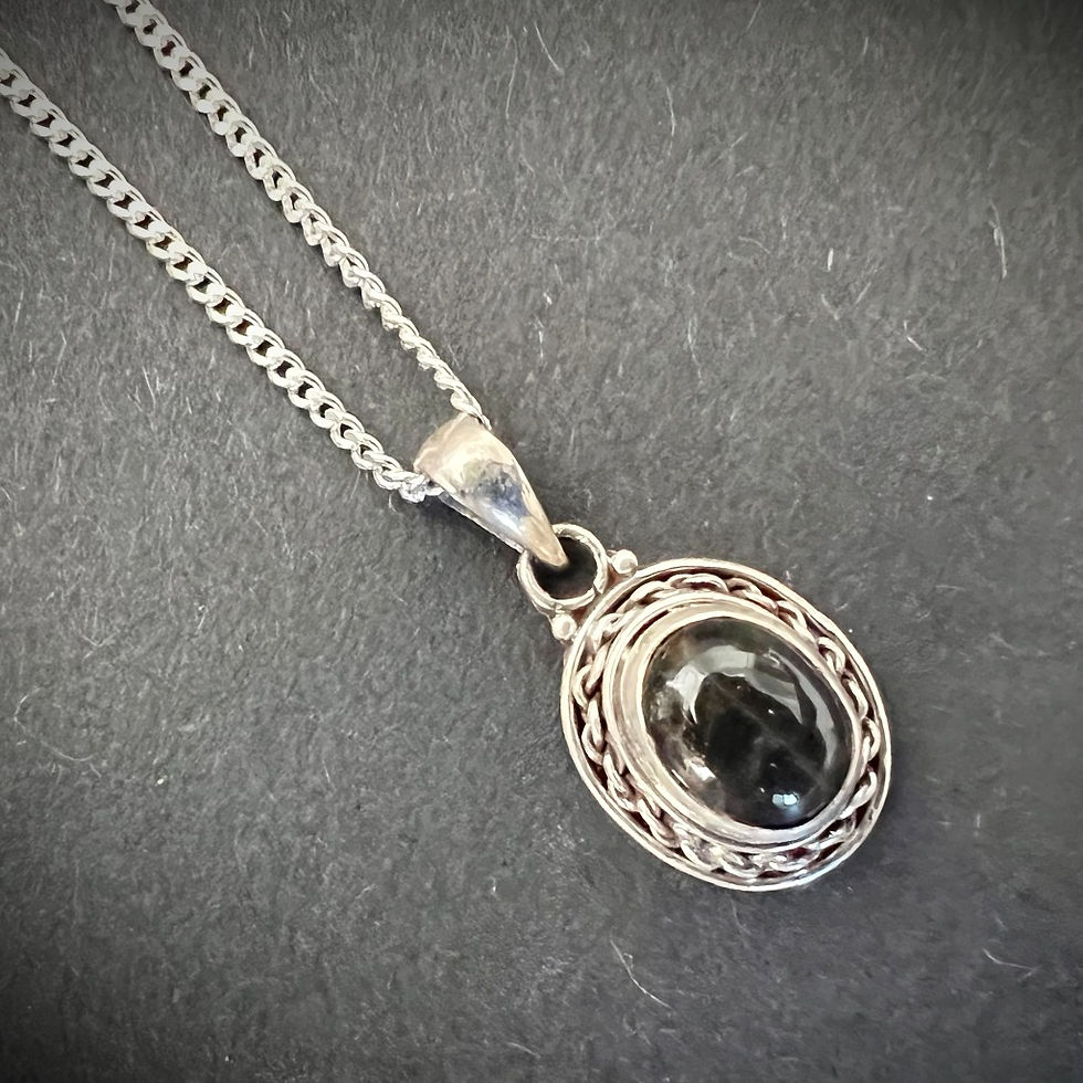 Thumbnail: Black Onyx Pendant Necklace with detailing around the onyx stone suspended from a  fine silver plated brass chain.