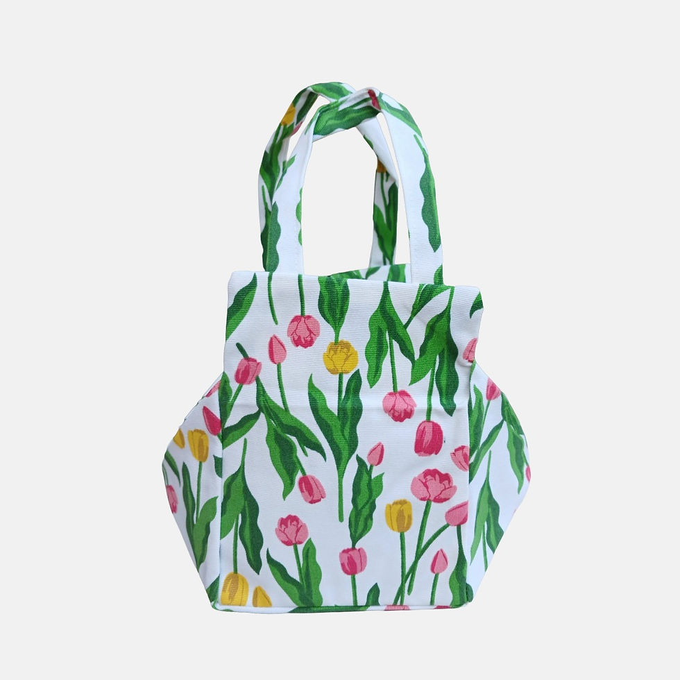 Floral tulip print zipper bag in 100% cotton fabric and finished with matching patterned handles and secure zipper closure.