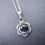 Thumbnail: A simple handcrafted necklace featuring a black Onyx pendant with floral detailing hung from a silver plated fine chain.