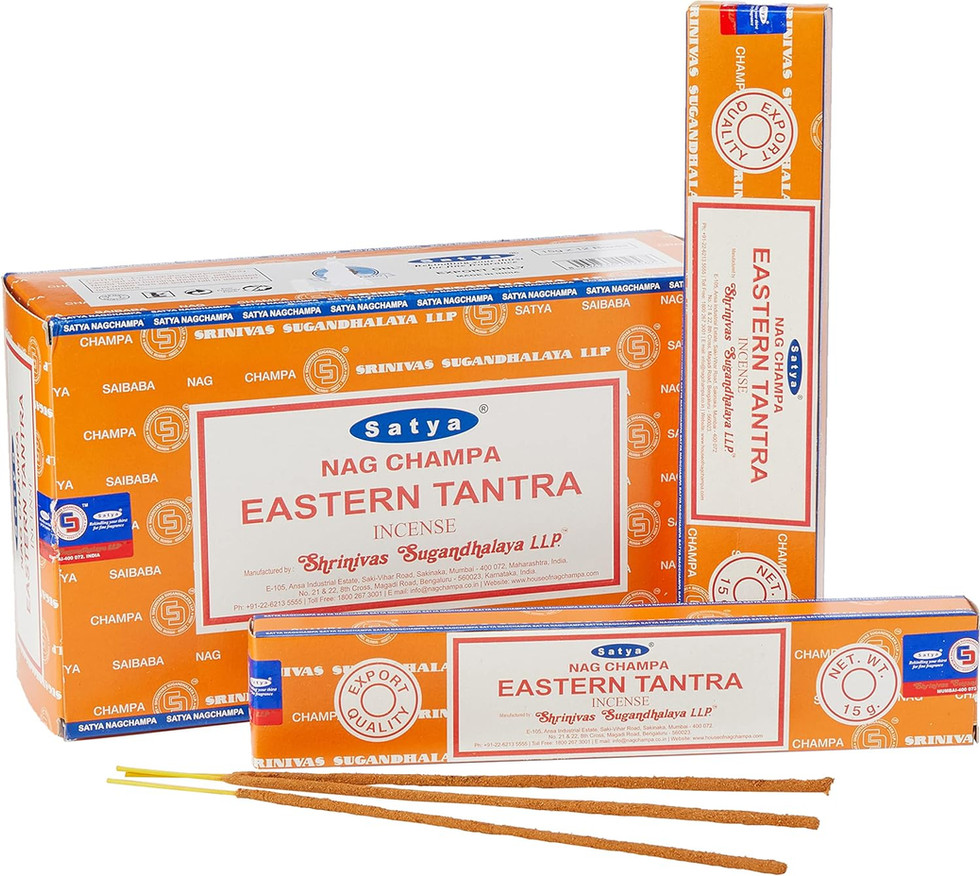 Nag Champa Eastern Tantra Incense sticks, close up on orange background.