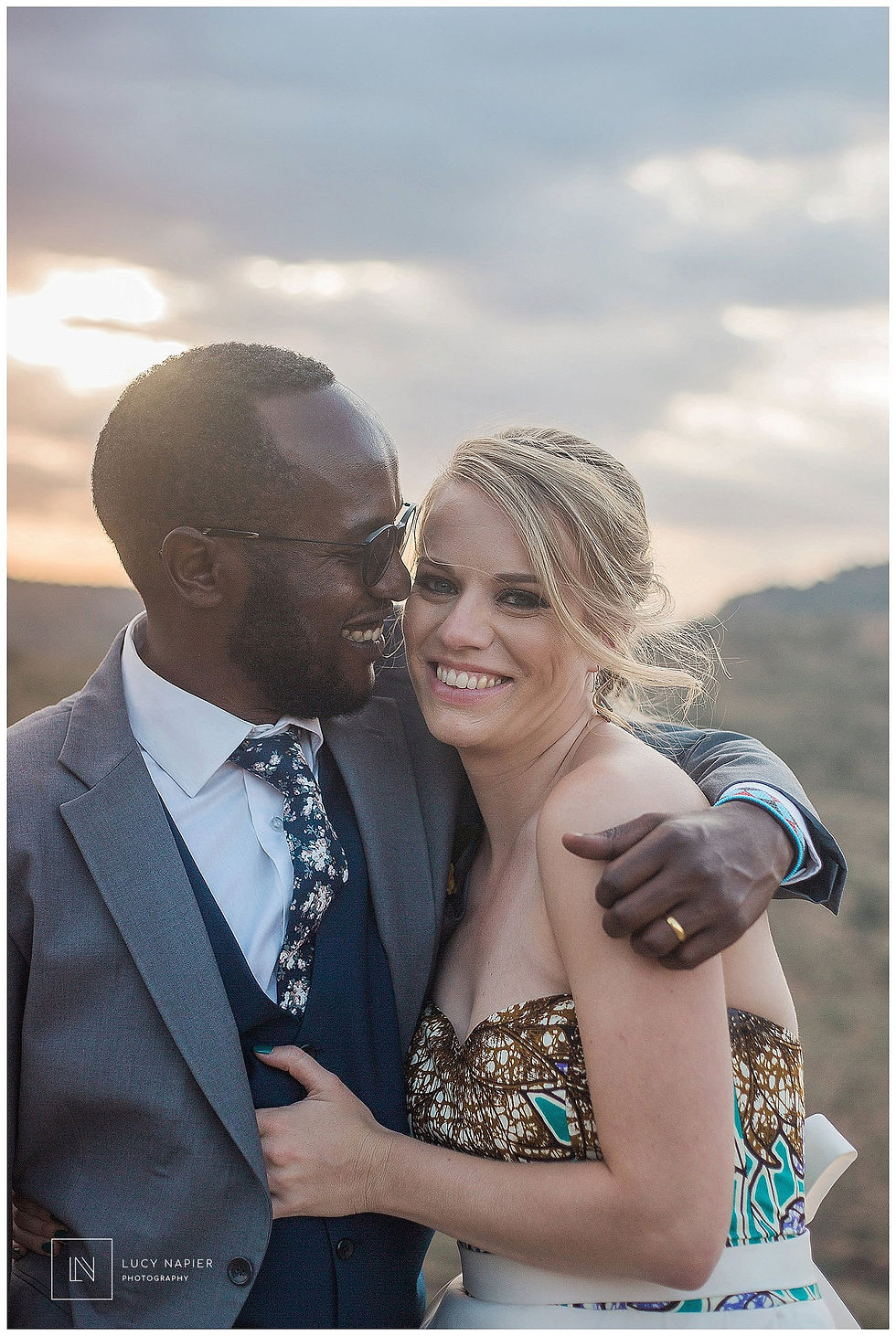 the bride and groom smile together