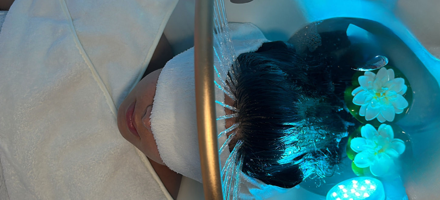 Vitality Vibe Spa rejuvenating Japanese head spa treatment with client lying peacefully under golden waterfall halo - where wellness begins at the root