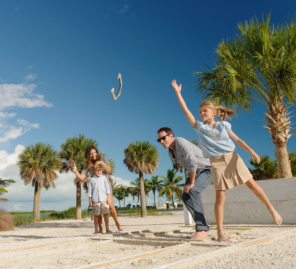 family in Turks and Caicos playing horseshoes