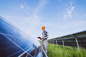 man-worker-firld-by-solar-panels.jpg
