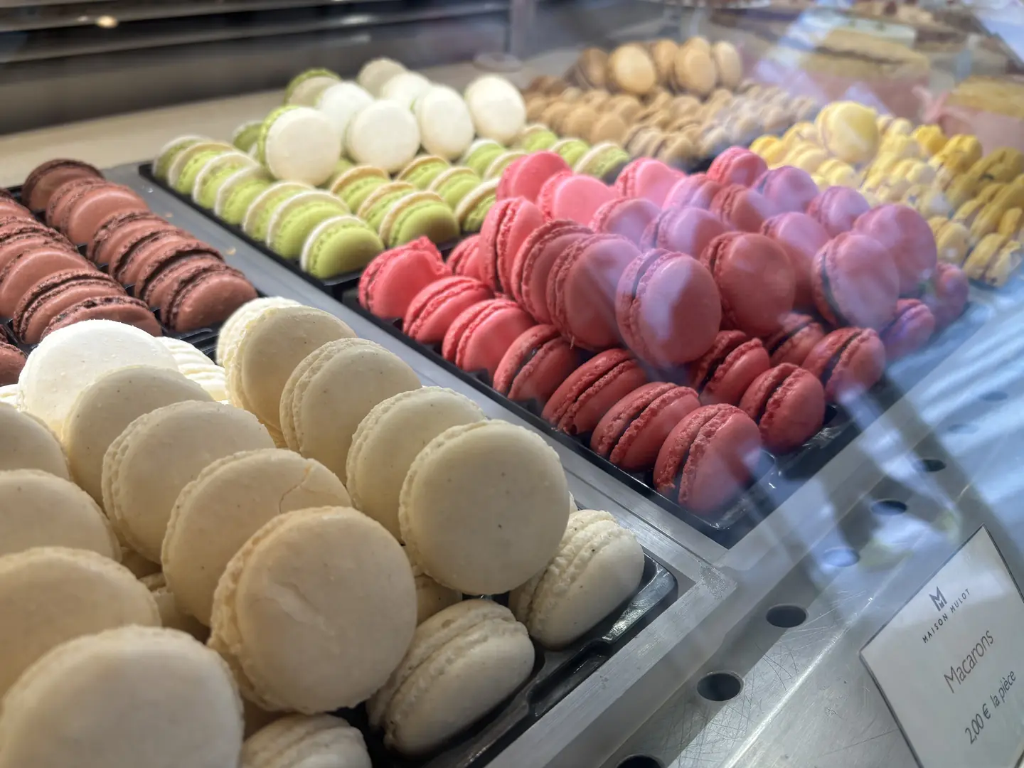 Colorful macarons display at Maison Mulot patisserie in Saint-Germain, Paris