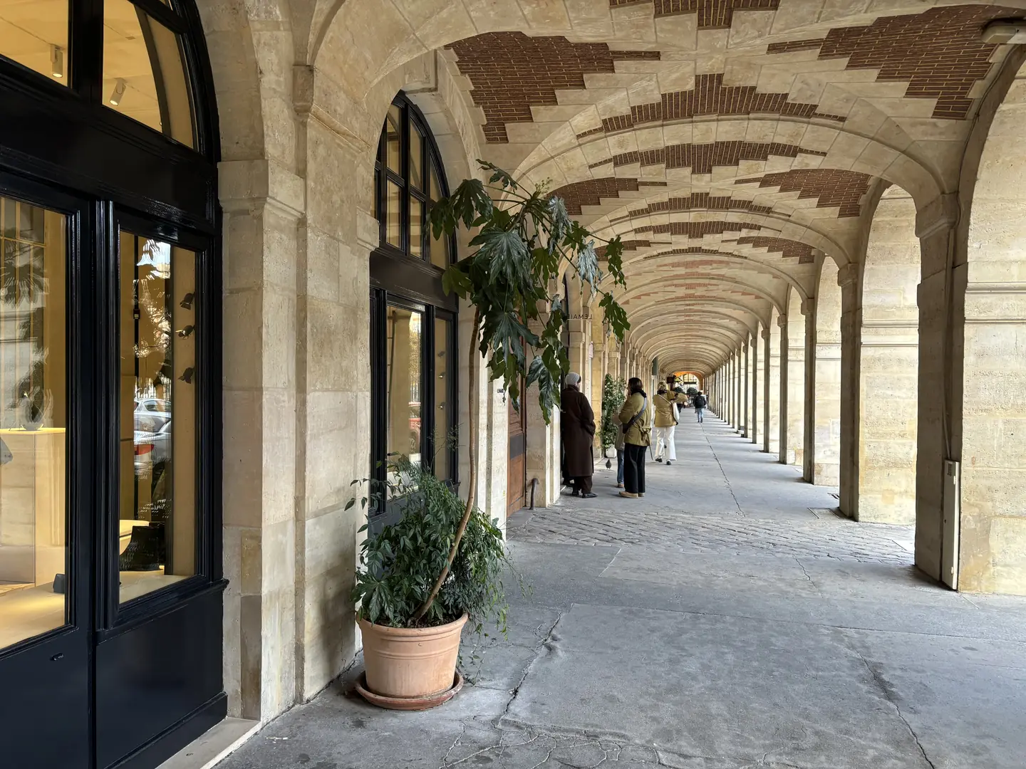 Historic arcades of Place des Vosges in the Marais, Paris