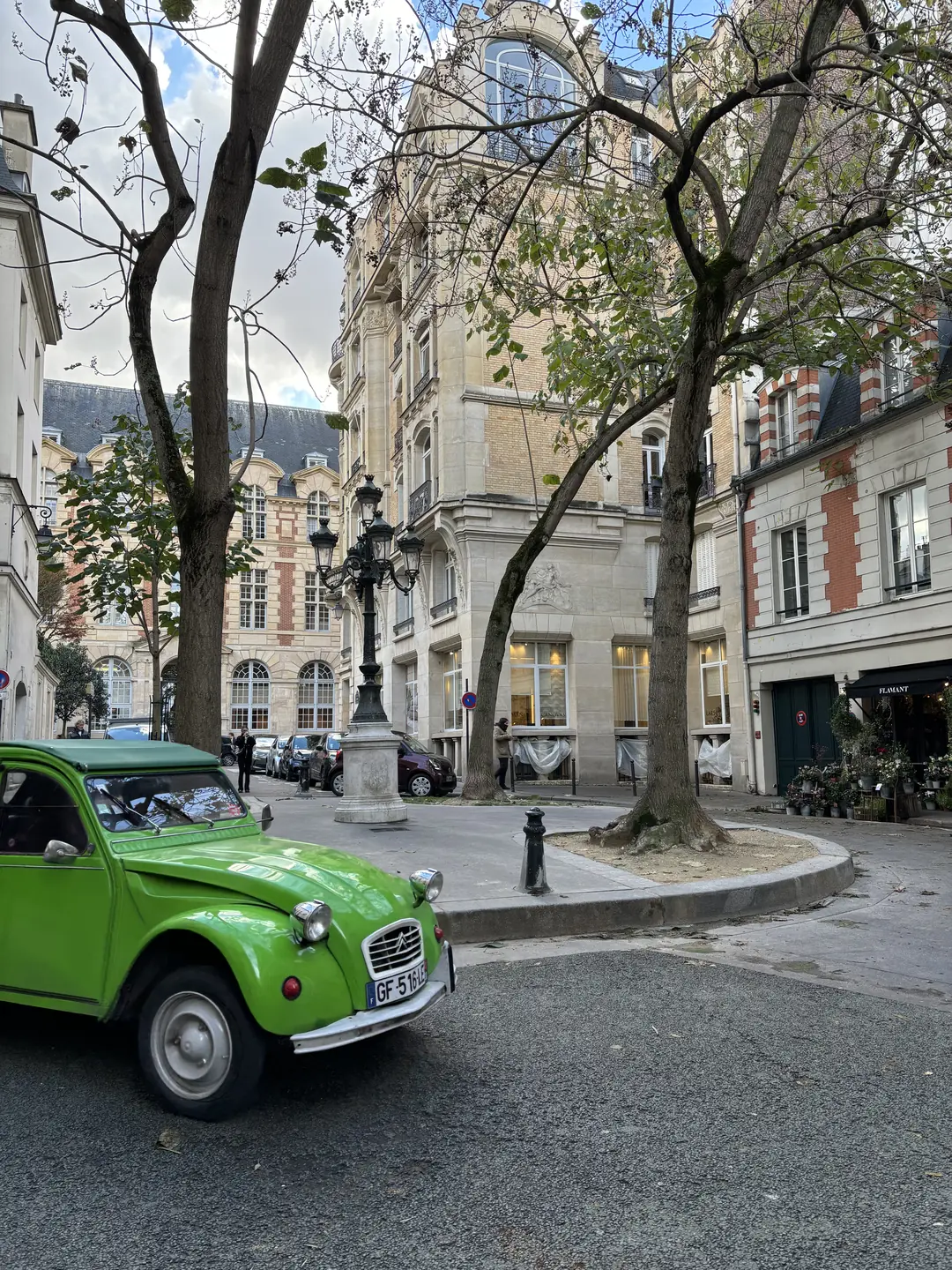 Vintage green Citroën 2CV parked on Place Furstenberg in Saint-Germain, Paris