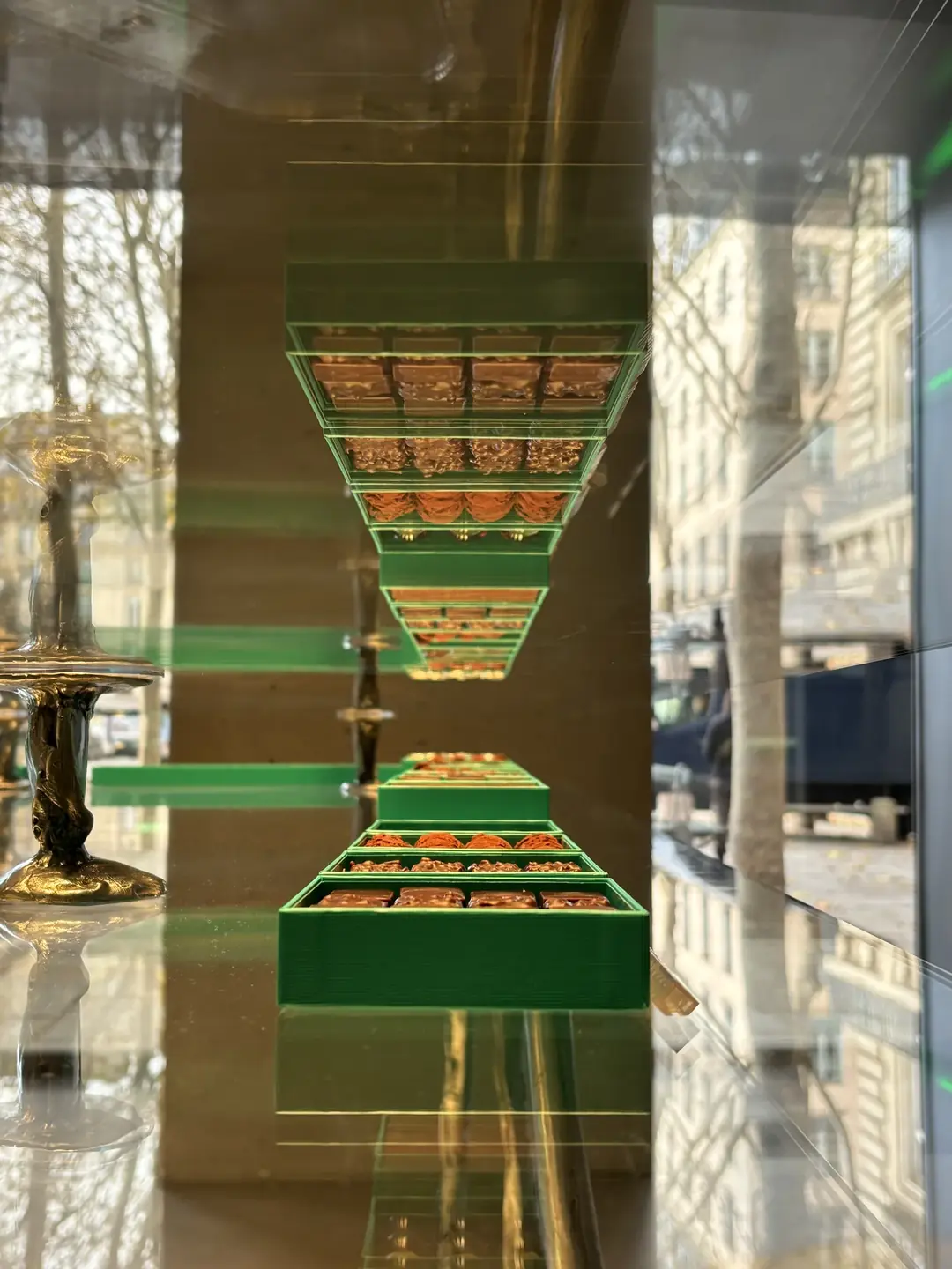 Patrick Roger chocolate shop window display with signature green packaging in Paris