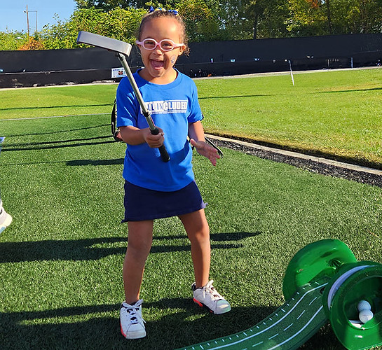 Young girl playing on golf course