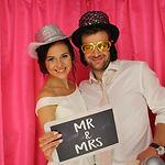 A newly married couple celebrate their wedding in the photo booth