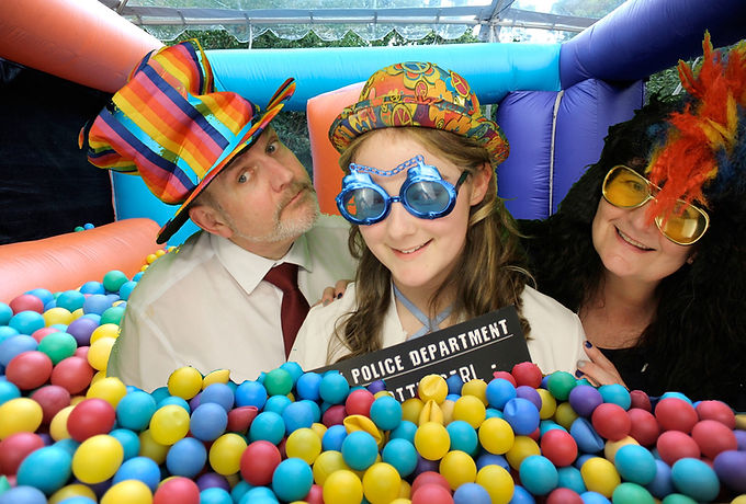 Family enjoying a photo booth at a wedding as if they were within a ball pit