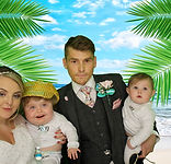 Young family posing in a photo booth at their wedding reception