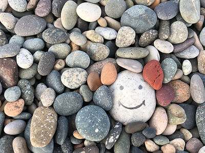 Stone with a painted smile. On the shore