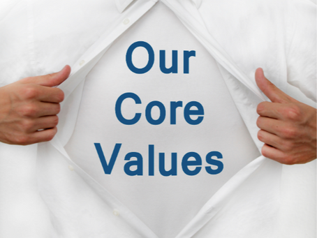Person opening shirt to reveal "Our Core Values" text, illustrating the gap between displayed values and how culture actually operates