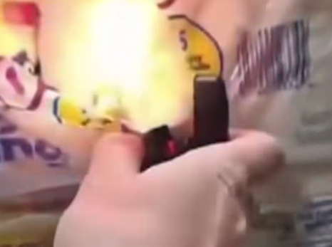 A hand holding a lighter with a flame, referencing the Kimberly-Clark warehouse fire sparked by employee disengagement