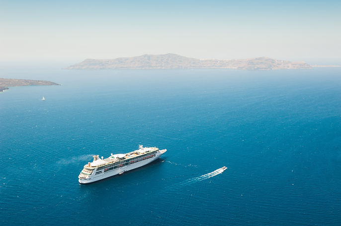Cruise ship near the Santorini island, Greece. Blue sky and the blue sea. Famous travel de