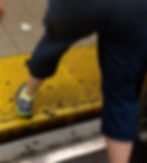 lower half of adult seen stepping past the gap and cane tip leading the way ahead.