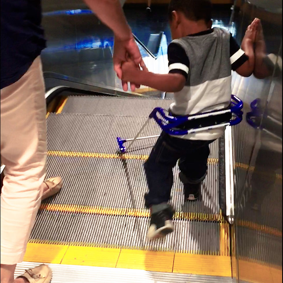 Eye-level view of a child walking confidently with a cane secured by a pediatric cane belt
