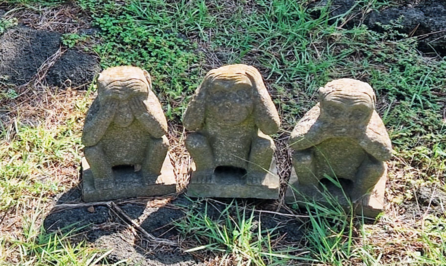 Three wise monkeys stone statue